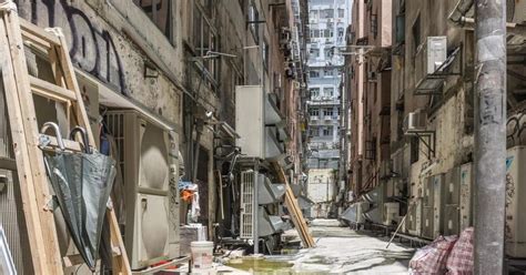 an alleyway with lots of graffiti on the walls and floor, including ladders