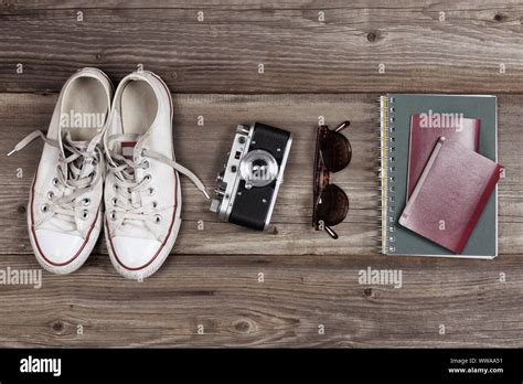 Essentials for modern young person travel. Sneakers, camera, sunglasses, notebook, passport and ...