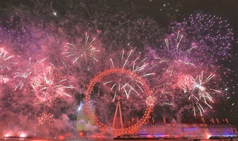 Fireworks explode around the London Eye wheel during New Year celebrations in central London.
