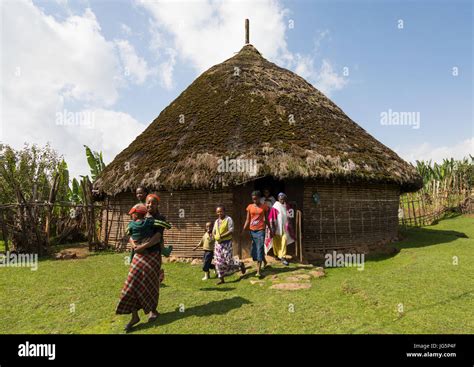 People in front of a Gurage traditional house with thatched roof, Gurage Zone, Butajira ...