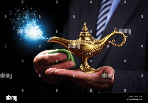 Rubbing magic Aladdins genie lamp Stock Photo: 68357735 - Alamy