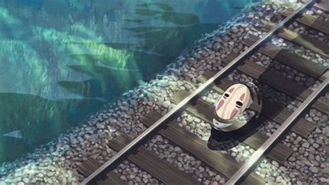 an aerial view of a train track and some fish swimming in the water next to it