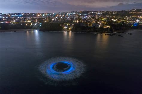 Neon bioluminescent waves fading after making the ocean glow off Southern California coast ...