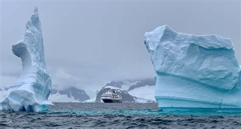 Hurtigruten ship between icebergs in Antarctica - Jackie J.Reid