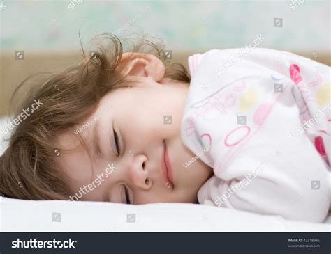 Beautiful Little Girl With Closed Eyes Lying In Bed And Smile Stock ...