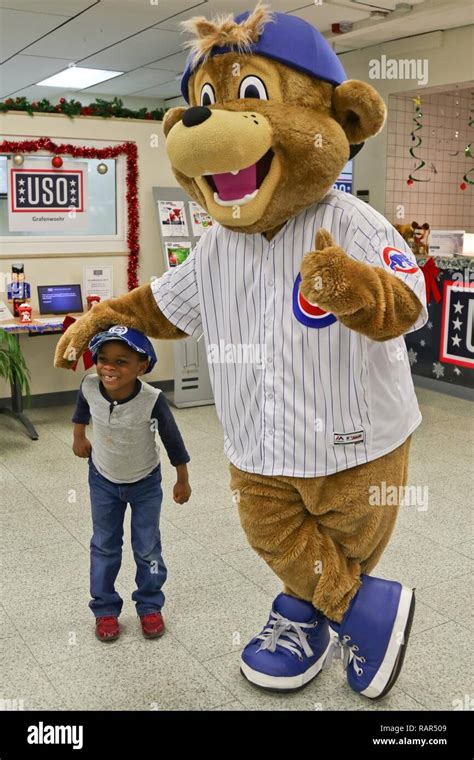 A U.S. Army Soldier’s son poses with Clark, the Chicago Cubs mascot, at the USO at USAG Bavaria ...