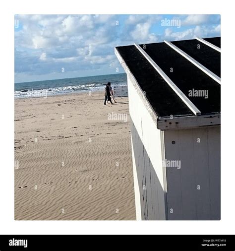 Two People Walking On Beach Stock Photo - Alamy