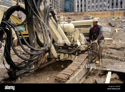 Drill operator with modified drill rig mounted on a backhoe platform ...