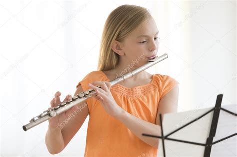 Girl Looking At Sheet Music While Practicing Flute — Stock Photo ...