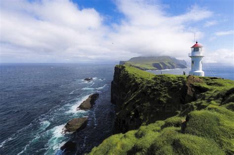 Lighthouse on islet known as Mykines Holmur, Mykines Island, Faroe Islands, Denmark, Europe ...