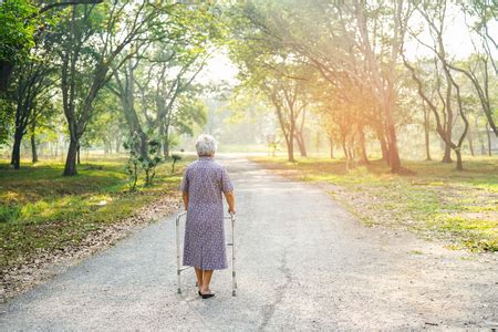 Asian senior or elderly old lady woman use walker with strong health while walking at park in ...