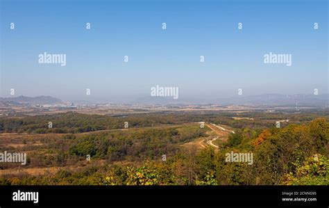 The border fence running through the Korean DMZ from South Korea, with ...