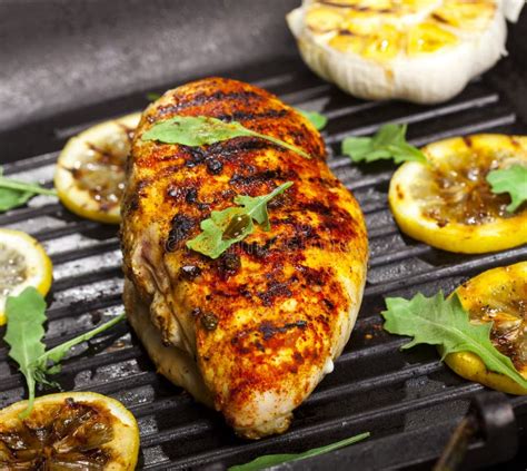 Grilled Chicken Fillet with Spices and Fresh Vegetables in a Pan on Black Background Stock Image ...