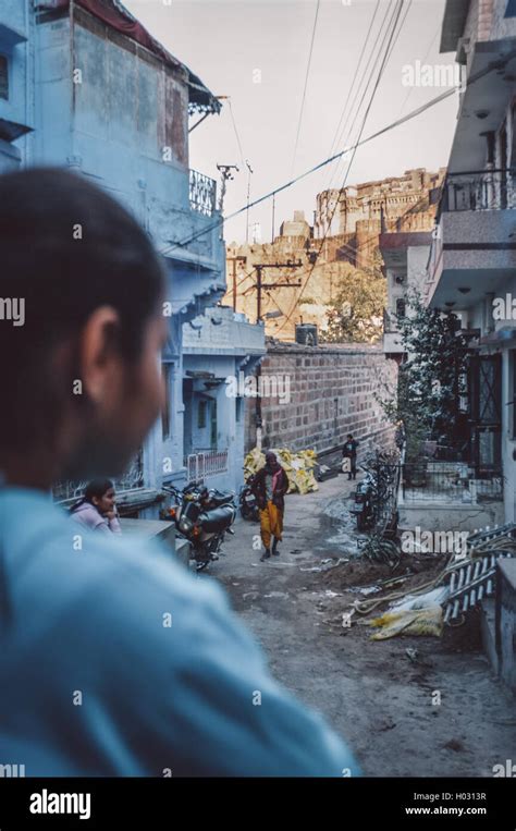 JODHPUR, INDIA - 07 FEBRUARY 2015: Indian girl stands in neighbourhood street and looks at ...