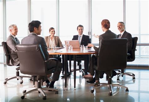 Business people meeting at table in conference room - Singapore Transcription