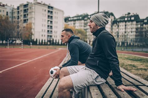 Soccer Players Sitting On A Bench Stock Photo - Download Image Now - iStock