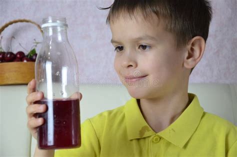 Cute Little Boy Drinking Juice At Home, Cherry Juice Drinks From A ...