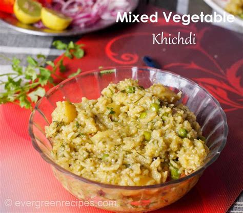 mixed vegetable khichad in a glass bowl on a red place mat next to other food items