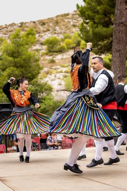 Premium Photo | Spanish people wearing traditional clothes dancing