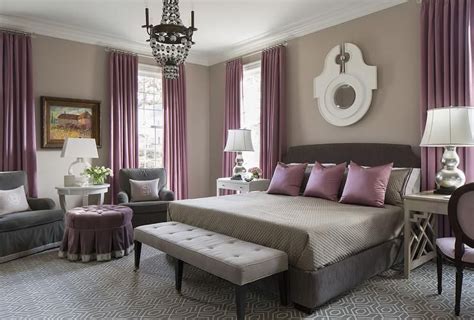 Purple and gray bedroom features walls painted warm gray lined with a dark gray bed dressed in ...