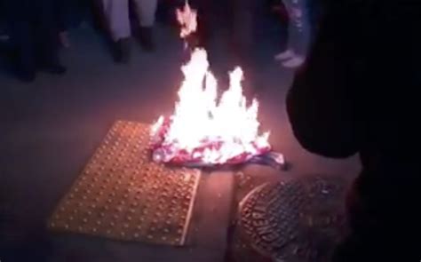 Portland protesters burn an American flag hanging outside the Justice ...