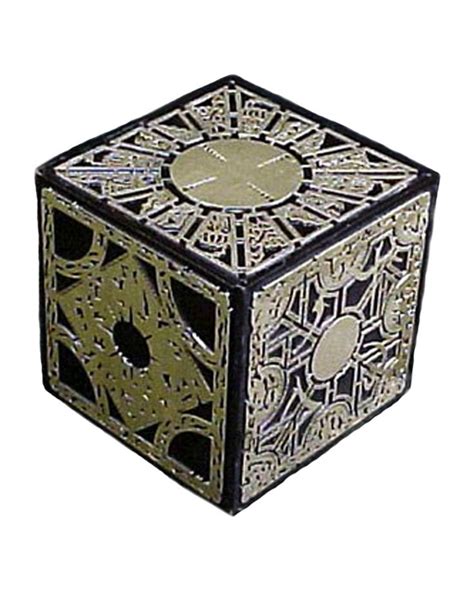 an intricately designed metal object on a black surface with holes in ...