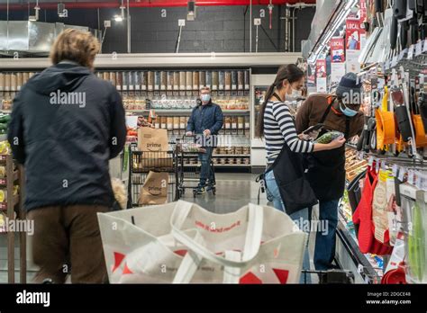 Workers and customers in the produce department in the Whole Foods ...