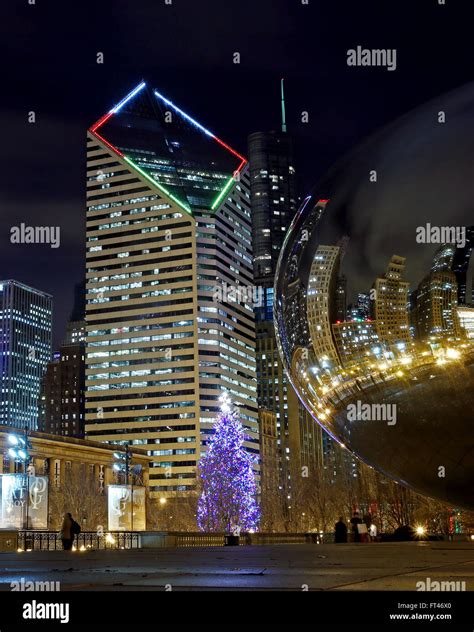 The Chicago Christmas tree is seen in Millennium Park between the Crain ...