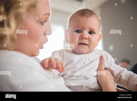 Mother holding her crying baby Stock Photo - Alamy