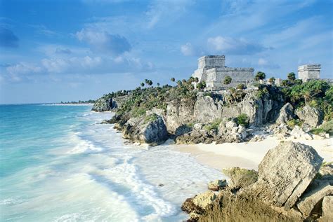 The ruins of Tulum preside over a rugged coastline, a strip of brilliant beach and green-and ...