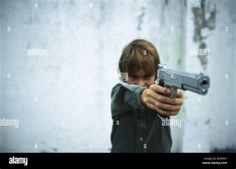 Boy pointing gun Stock Photo - Alamy