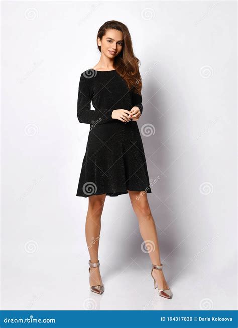 Model with Flowing Dark Hair in Posh Black Dress and Silver Shoes ...