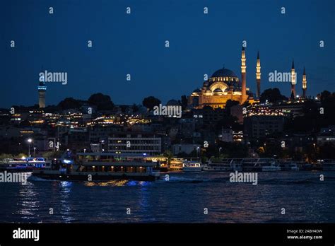 Istanbul, Turkey: night skyline with boats in the Golden Horn and Suleymaniye mosque, Ottoman ...