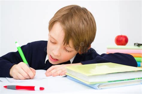 Schoolboy writing homework stock photo. Image of hair - 33211174