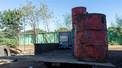 Premium Photo | Barrels with oil for recycling loaded on a truck