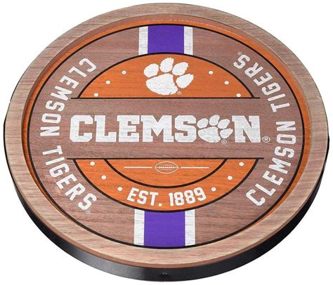 the clemson tigers logo is shown on an orange and purple striped wooden coaster that says clemson