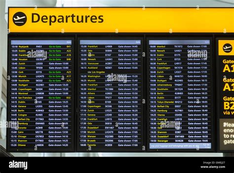 Flight departures information notice board sign at Heathrow airport Terminal 2 departure lounge ...