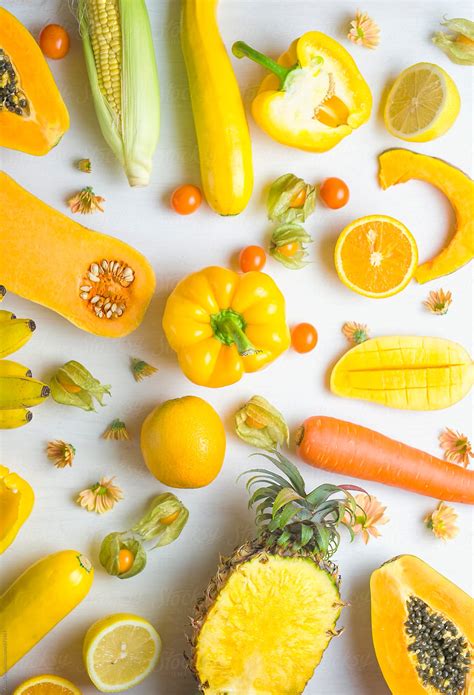 Yellow food on white background by Alita Ong - Stocksy United