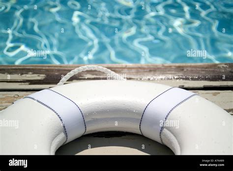 Life preserver on pool deck life jacket Stock Photo - Alamy