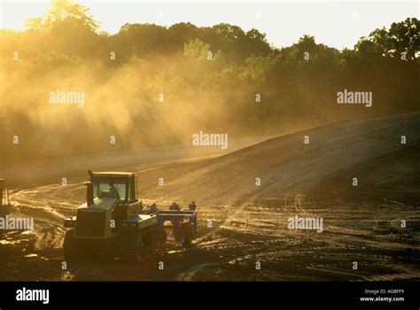 Caterpillar agricultural tractor with farm implement Stock Photo - Alamy