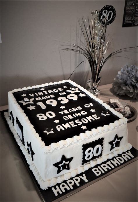 the birthday cake is decorated with black and white numbers, stars, and ...