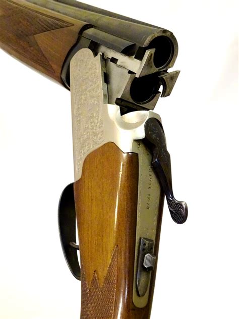 Shotgun: a Lanber 12 bore over and under single trigger ejector, walnut pistol-grip stock with ch