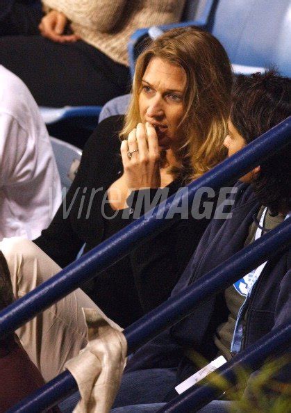 Steffi Graf watches Andre Agassi return a serve against James Blake ...