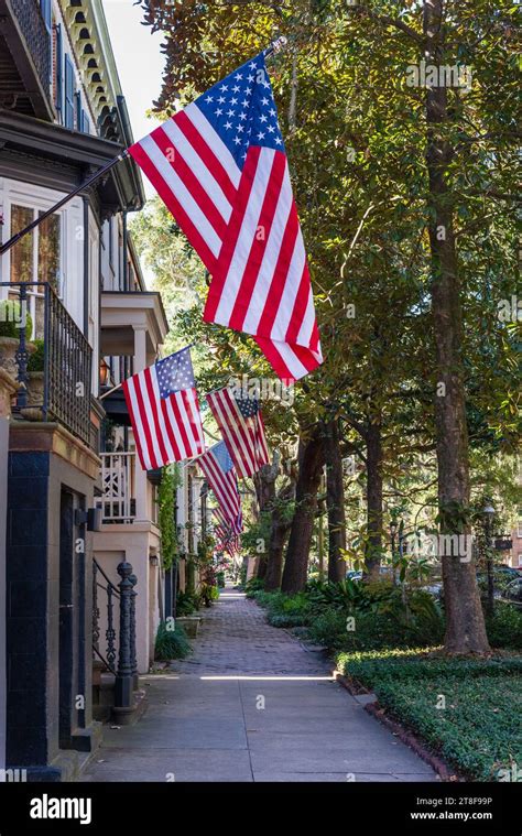 Savannah residential street and sidewalk with American flags hanging ...