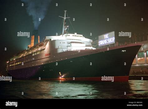 Bow view of the cruise liner Queen Elizabeth 2 tied up in Hong Kong at night Stock Photo - Alamy