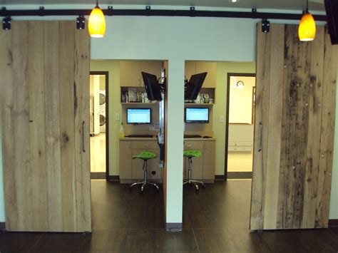 door for behind reception desk to call center Roswell Vet - Reclaimed barn doors opened to view ...