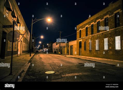 Dark and scary urban industrial city district at night Stock Photo - Alamy