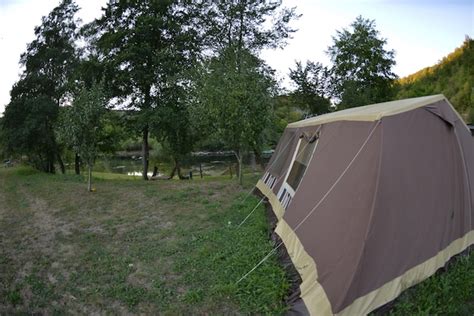 Premium Photo | Camping tent with in forest near the river at dusk