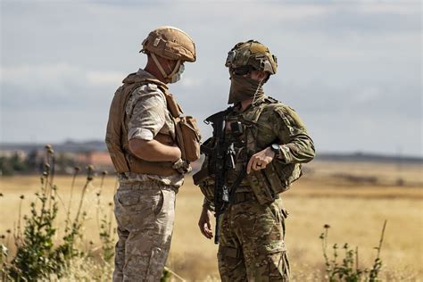 Russian MP and a US Army soldier talk after their convoys bumped into ...