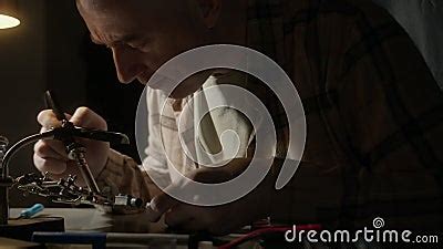 Man Solders Transistors, RadioElectronic Parts on Electronic Board with Soldering Iron.Repairing ...